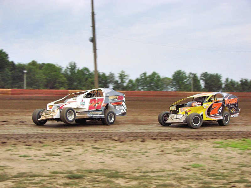 Chad James (27) races Modified feature winner Chic Cossaboone (7A) through turn two.