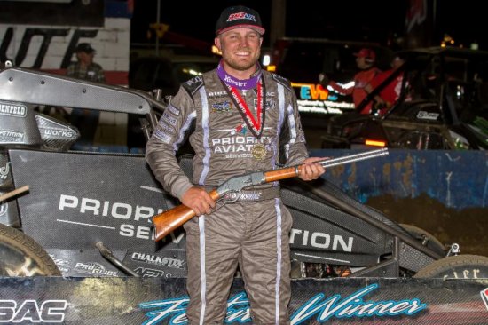 <strong>Tyler Courtney celebrates in victory lane with the 'Tony Hulman Classic' rifle after winning Wednesday night's USAC AMSOIL National Sprint Car feature at the Terre Haute (Ind.) Action Track. (Dallas Breeze Photo)</strong>